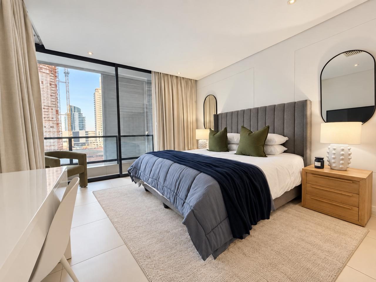 Bedroom with navy throw and city view