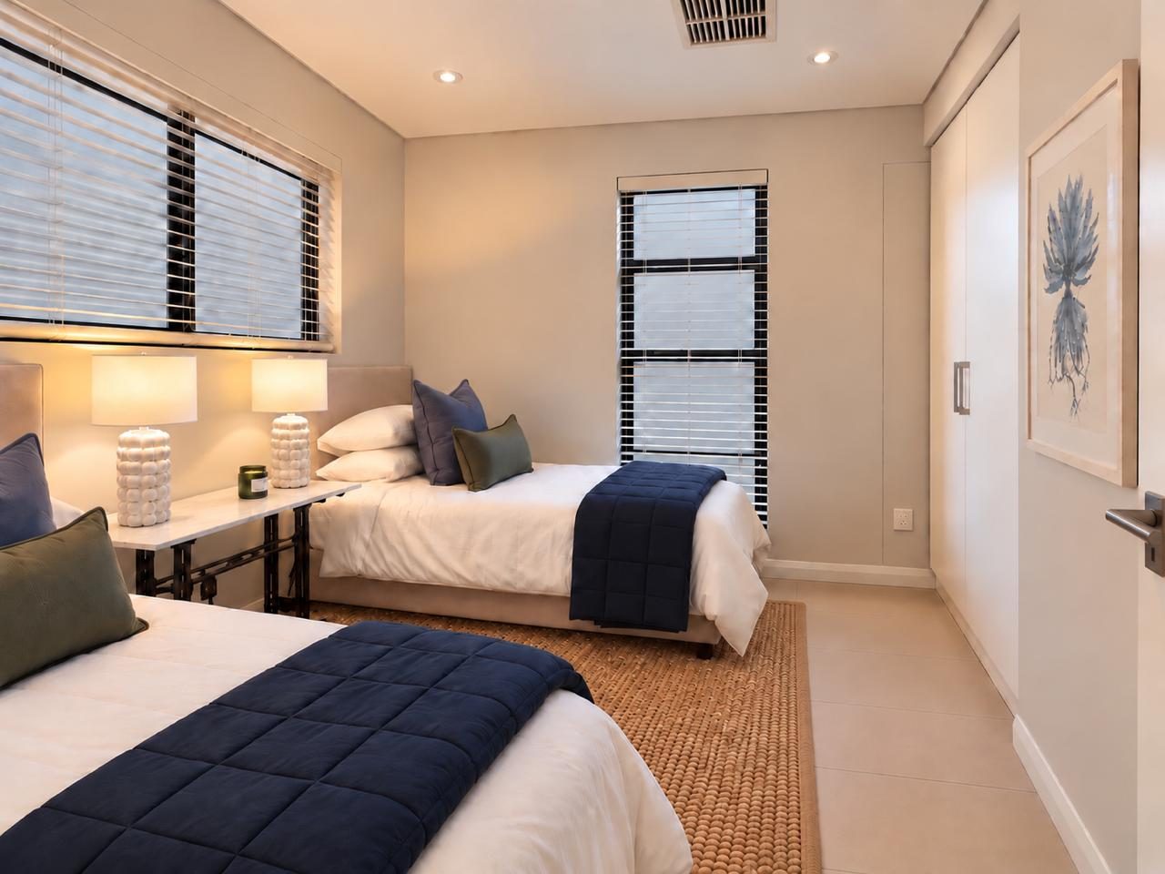 Twin bedroom with navy quilts